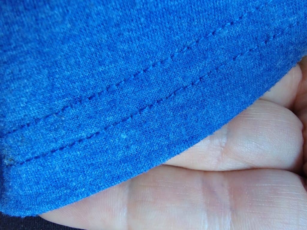 Front of coverstitch on blue fabric.